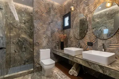 a bathroom with two sinks and a mirror at Elysian Villa in Afantou
