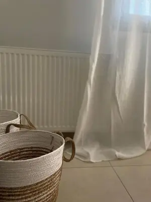 a white plastic bag next to two baskets on a floor at Casa de Manu in Rhodes Town