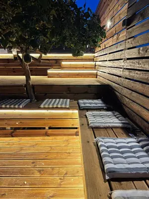 a sauna with a tree on a wooden deck at Casa de Manu in Rhodes Town