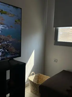 a living room with a flat screen tv on a wall at Casa de Manu in Rhodes Town