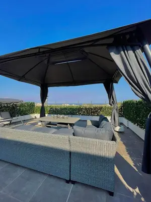 a large black umbrella on top of a patio at Villa de Manu in Rhodes Town