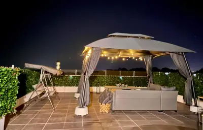 a large umbrella on a patio at night at Villa de Manu in Rhodes Town