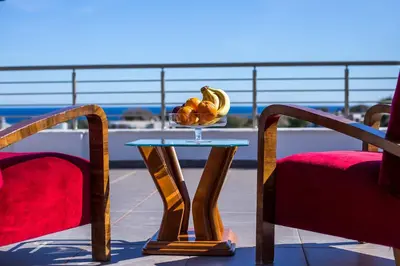 a bowl of fruit on a table on a balcony at Villa de Manu in Rhodes Town
