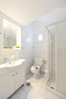 a bathroom with a toilet and a sink and a shower at Venus Island Studios in Líndos