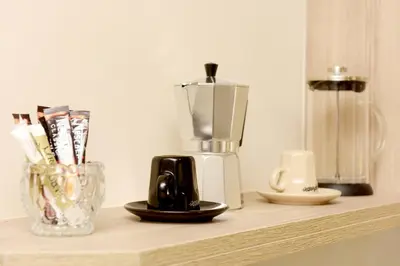 a counter with a blender and a vase on it at Venus Island Studios in Líndos