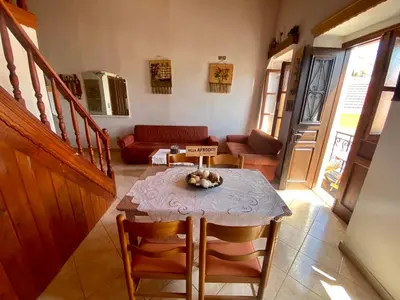 a living room with a table and a couch at Villa Afroditi in Halki