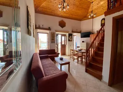 a living room with a couch and a table at Villa Afroditi in Halki