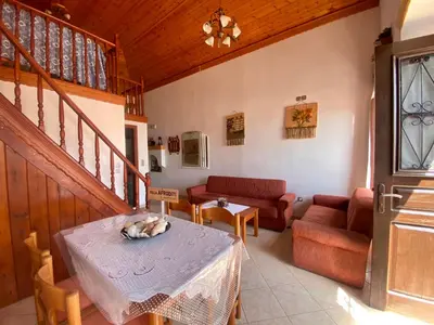 a living room with a table and a couch at Villa Afroditi in Halki