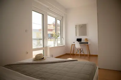 a bedroom with a bed with a hat on it at Beach house 30 in Ialyssos