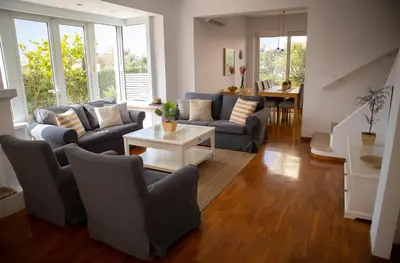 a living room with couches and a table at Beach house 30 in Ialyssos