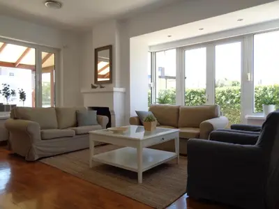 a living room with two couches and a coffee table at Beach house 30 in Ialyssos