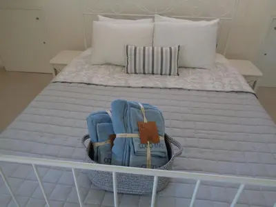 a bed with two backpacks on top of it at Beach house 30 in Ialyssos