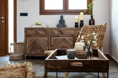 a living room with a coffee table and a chair at Luxury NissoVilla with Private Pool & Sea Views in Kolimbia