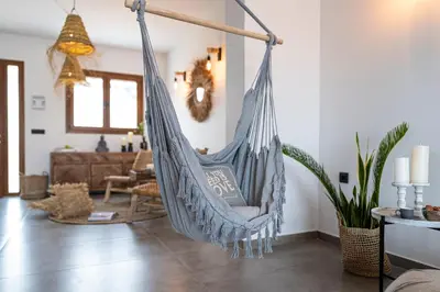 a hammock hanging in a living room at Luxury NissoVilla with Private Pool & Sea Views in Kolimbia