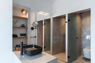 a bathroom with a sink and a toilet at Luxury NissoVilla with Private Pool & Sea Views in Kolimbia