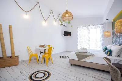 a bedroom with a bed and a table and chairs at Marini Seaside in Faliraki