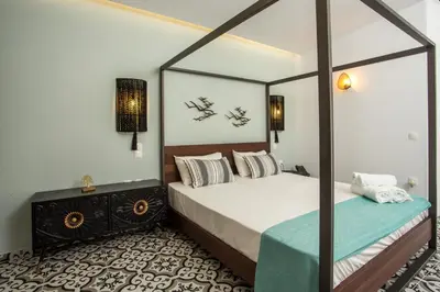 a bedroom with a bed and a mirror at Marini Seaside in Faliraki