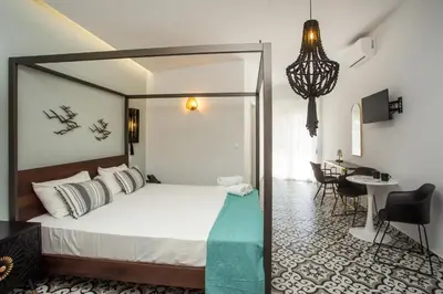 a bedroom with a bed and a desk in a room at Marini Seaside in Faliraki