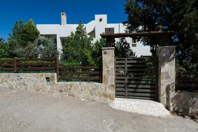 a wooden fence in front of a house at Emerald Dawn Villa in Pefki Rhodes