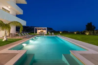 a swimming pool in the backyard of a house at Pantheon Luxury Villas Rhodes Island in Afantou