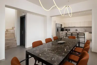 a dining room with a black table and chairs at Pantheon Luxury Villas Rhodes Island in Afantou