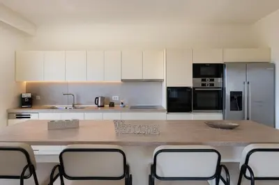 a kitchen with a large wooden table with chairs at Pantheon Luxury Villas Rhodes Island in Afantou