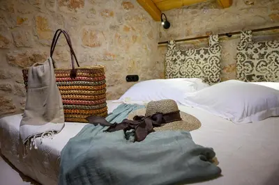 a bed with a hat and a basket on it at Villa Phaedra in Halki