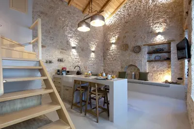a kitchen with a counter and a table in a room at Villa Phaedra in Halki
