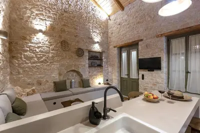 a living room with a couch and a sink at Villa Phaedra in Halki