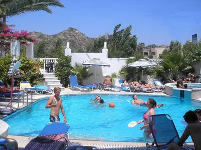 a group of people playing in a swimming pool at White Palace Pavlos apartment1 in Faliraki