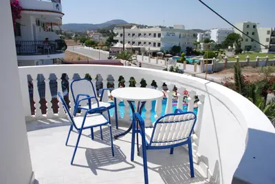 a table and chairs on a balcony with a view at White Palace Pavlos apartment1 in Faliraki