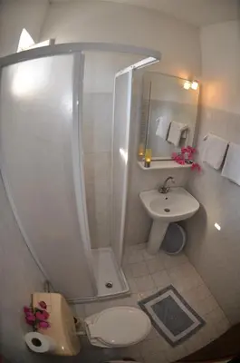 a bathroom with a shower and a toilet and a sink at White Palace Pavlos apartment1 in Faliraki