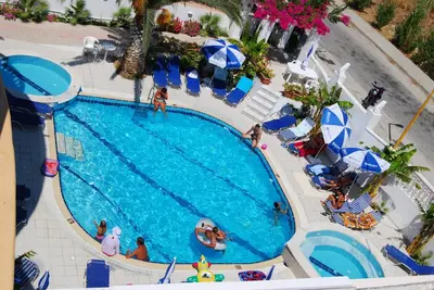 an overhead view of a swimming pool at a resort at White Palace Pavlos apartment1 in Faliraki