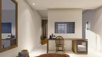 a living room with a chair and a desk at Lindos View Hotel in Líndos