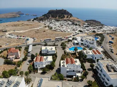 an aerial view of a town with white buildings and the ocean at Lindos View Hotel in Líndos