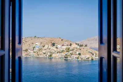 a view from a train window of a body of water at Marea Apartments in Symi