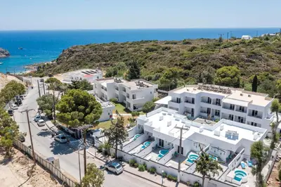 an aerial view of a white building with the ocean in the background at CASA MIKELE by Sarikas - SEA SIDE SUITES and STUDIOS -adults only in Faliraki