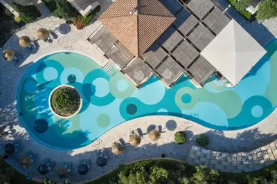an overhead view of a swimming pool with umbrellas at Atlantica Aegean Park in Kolimbia