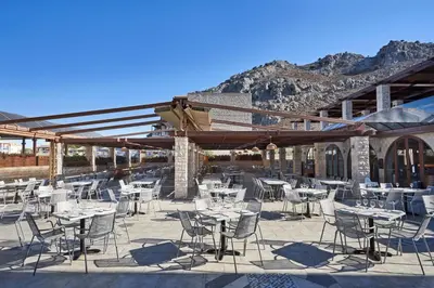 a group of tables and chairs on a patio at Atlantica Aegean Park in Kolimbia