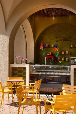 a group of tables and chairs in a restaurant at Atlantica Aegean Blue in Kolimbia