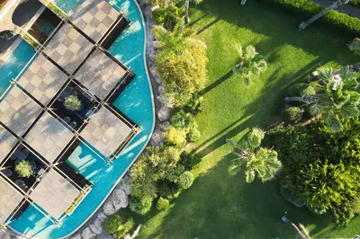an overhead view of a pool with trees and grass at Atlantica Aegean Blue in Kolimbia