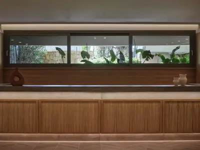 a restaurant with a window with a fish tank at Atlantica Aegean Blue in Kolimbia