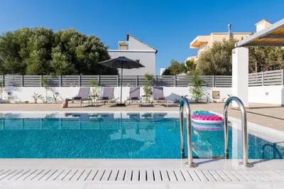 a swimming pool with a pool noodle in a resort at South Beach Villas in Gennadi