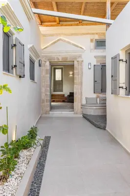 an internal courtyard of a house with a walkway at Melitia Traditional House in Koskinou