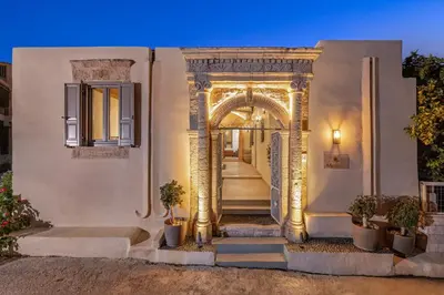 an entrance to a house with an arch and plants at Melitia Traditional House in Koskinou