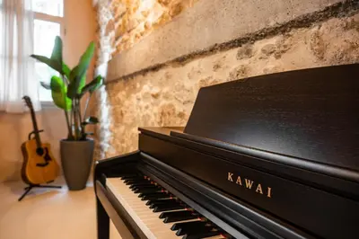 a black piano sitting next to a brick wall at Casa Emiliana in Rhodes Town