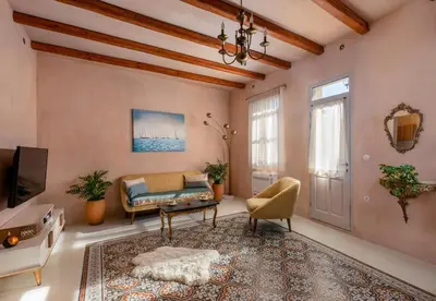 a living room with a couch and a tv at Casa Emiliana in Rhodes Town