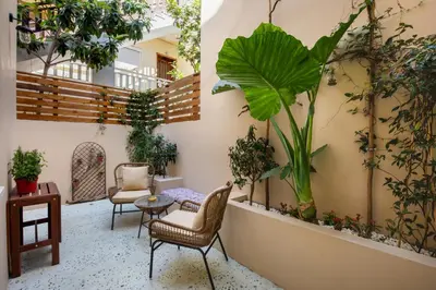 a courtyard with chairs and plants on the wall at Casa Emiliana in Rhodes Town