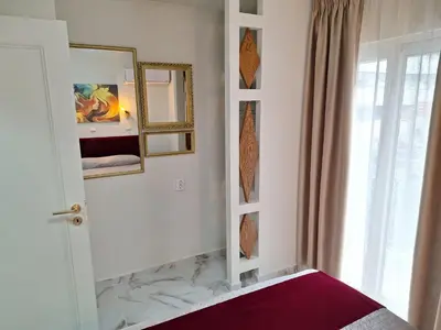 a white room with a mirror and a window at Modern Quiet Apartment in the Center of Rhodes in Rhodes Town