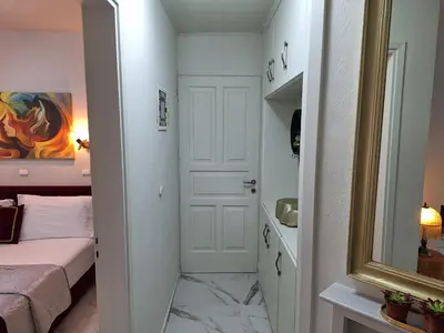 a small bedroom with a bed and a mirror at Modern Quiet Apartment in the Center of Rhodes in Rhodes Town